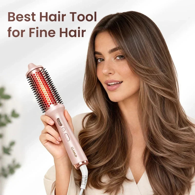 A woman holding the pink GLAMUP Infrared Thermal Brush with glowing red light technology, showcasing the best heated hair tool to add lasting volume and curls to fine hair types.