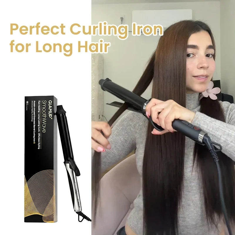 A woman with long, sleek brunette hair styling her hair using the GLAMUP SmoothWave™ extended barrel curling iron, next to its sleek black and gold retail packaging box.