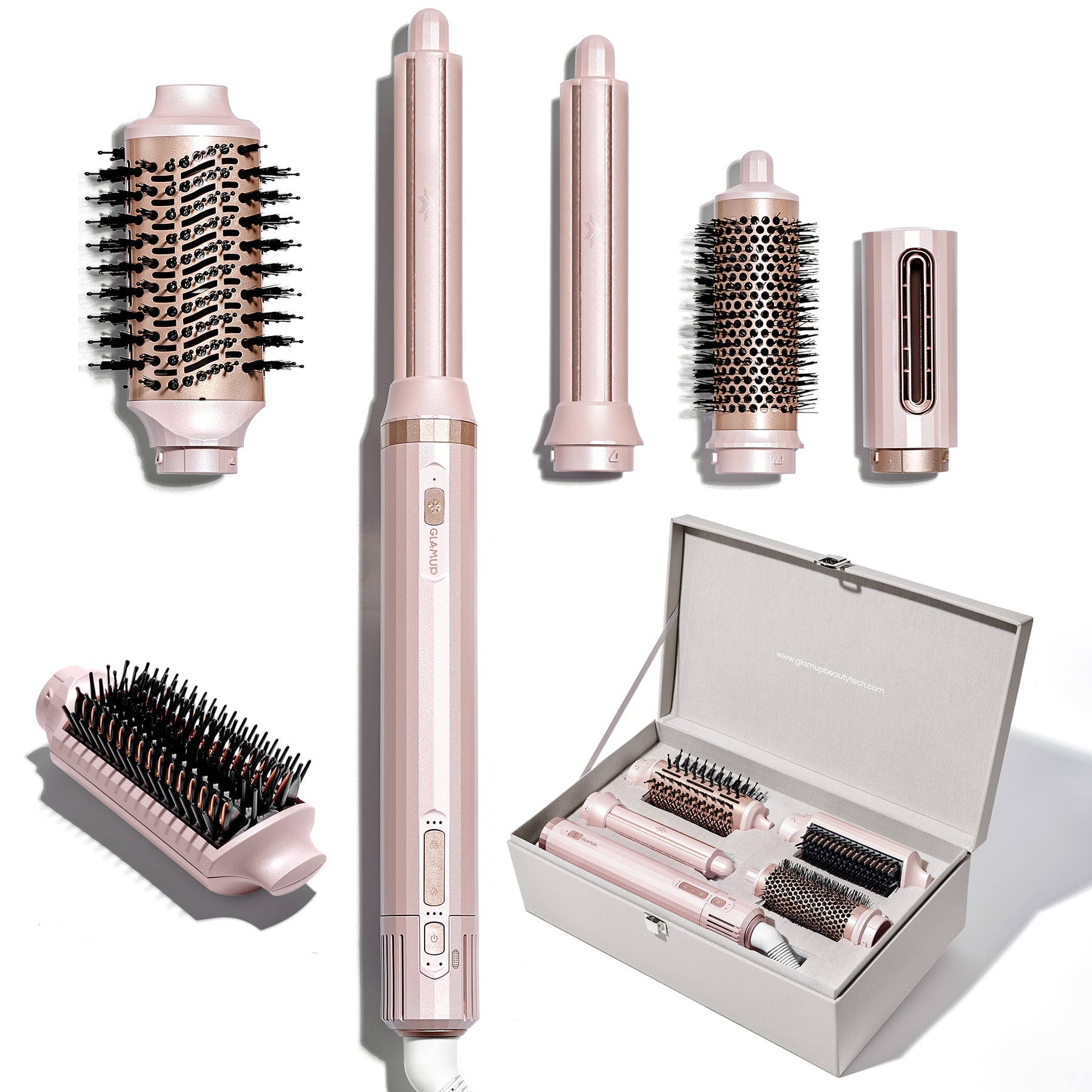 Set of pink hair styling tools including a straightener, brush, and attachments on a white background.