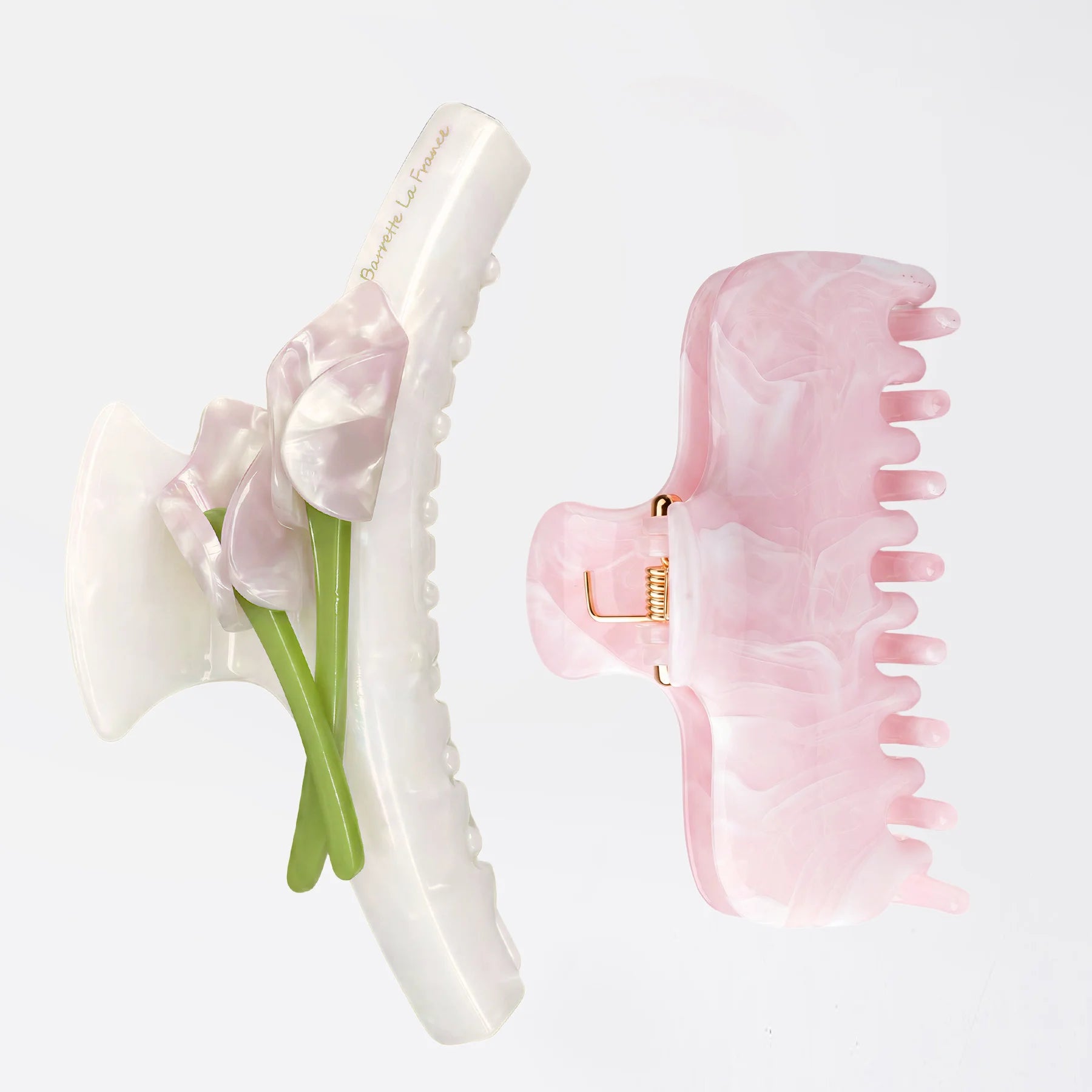 Studio shot of the Glamup Flora Large Claw Clip Set, featuring one white floral clip with tulips and one pink marbled clip designed for thick hair.