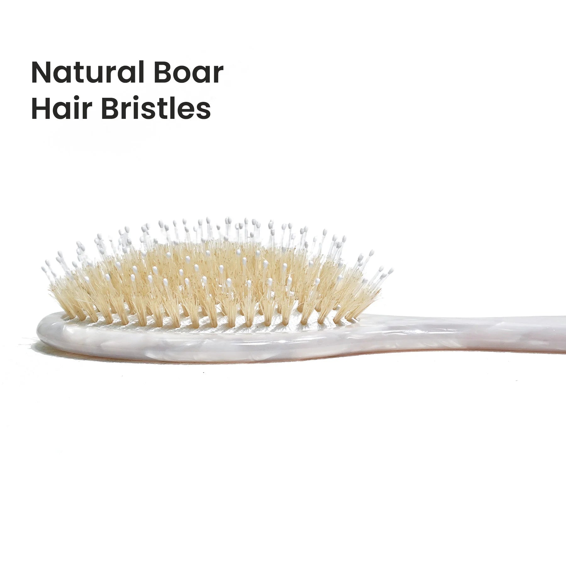 Detailed view of the Glamup cushion brush head with pure white boar bristles and massage nylon pins, designed to distribute natural oils and boost shine.