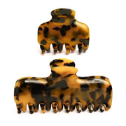 Studio display of the Glamup "The Jennie" Tortoise Acetate Claw Clip Set, featuring one M size and one XS size clip for versatile styling.