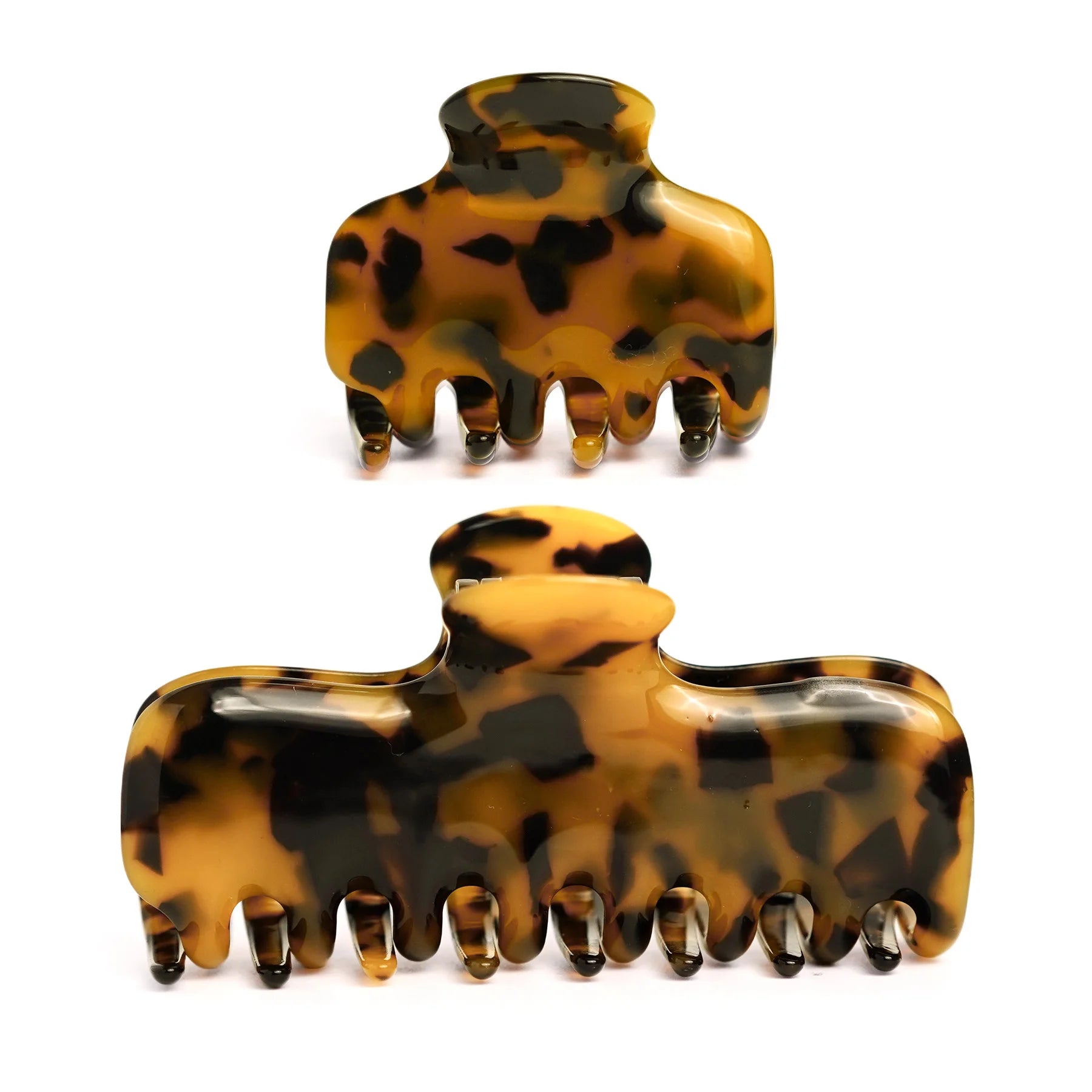 Studio display of the Glamup "The Jennie" Tortoise Acetate Claw Clip Set, featuring one M size and one XS size clip for versatile styling.