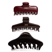 Studio display of the Glamup The Taylor claw clip for thick hair in a dark color set, featuring an XL jumbo size and double-row teeth for all-day hold.