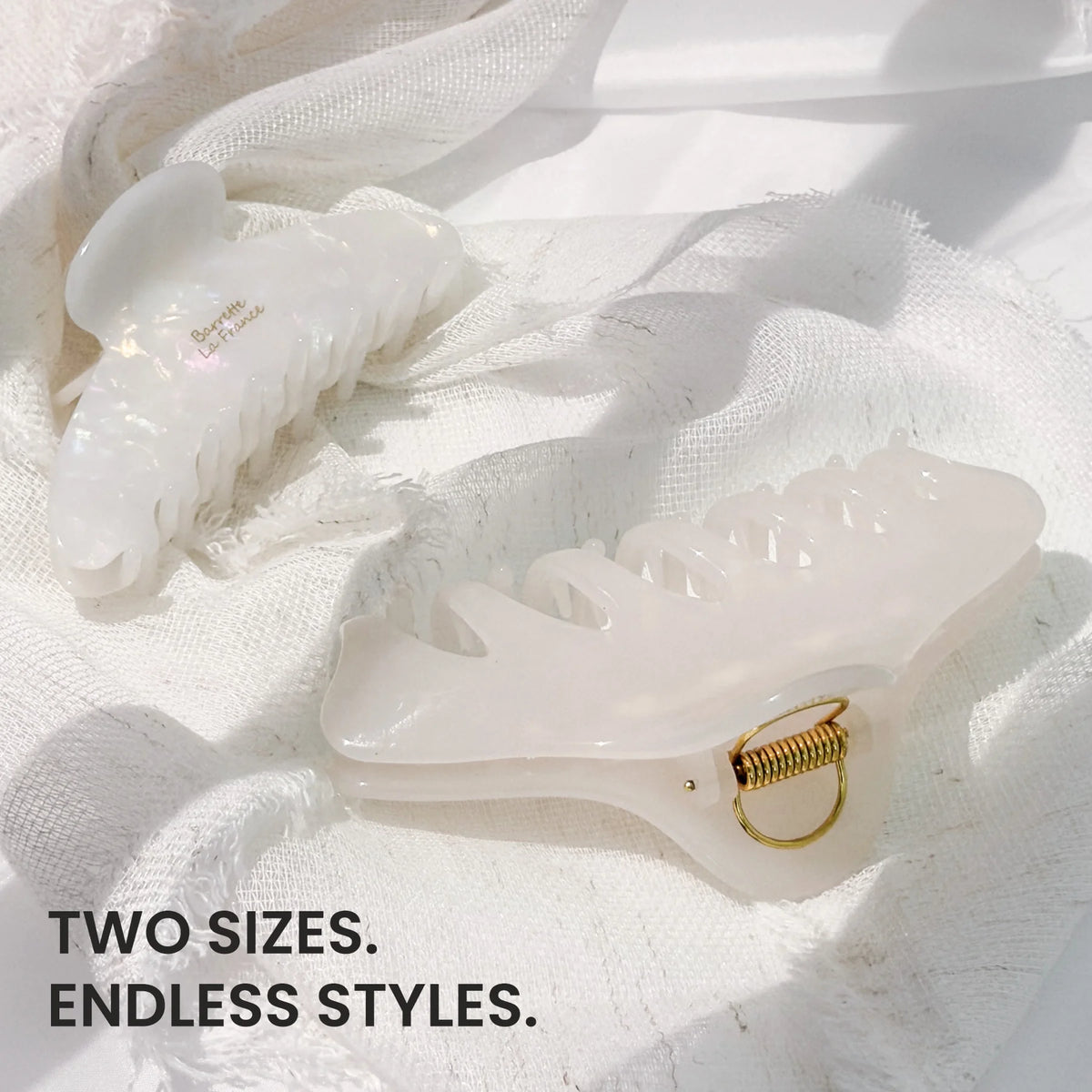 Two different sizes of the light Glamup The Taylor claw clip displayed together, engineered with double-row teeth for thick hair.